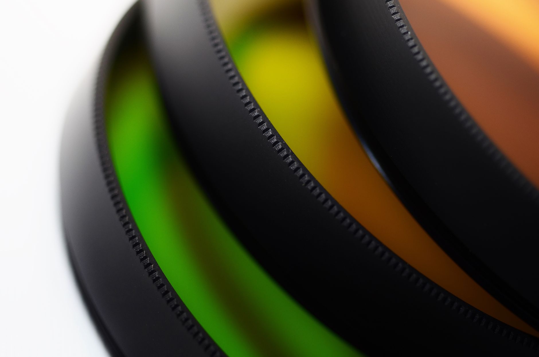 Close-up view of multi-colored camera lens filters showcasing texture and vibrant hues.