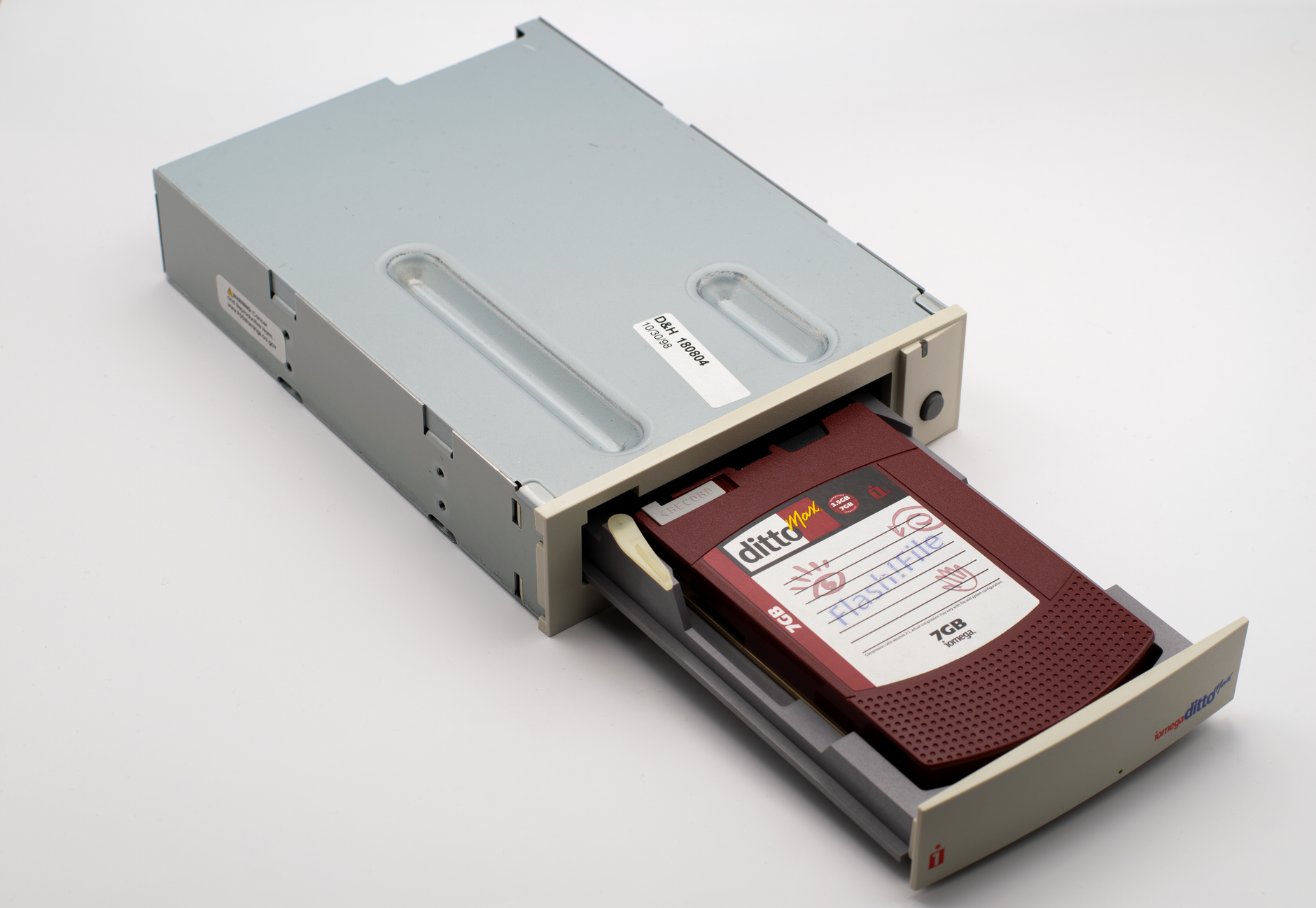 A vintage DittoMax tape drive showcasing an inserted 7GB cartridge.