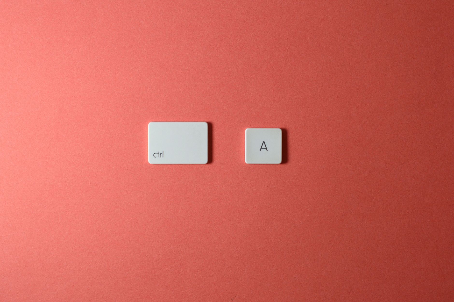 White ctrl and A keys on a simple red background create a minimalist and modern look.
