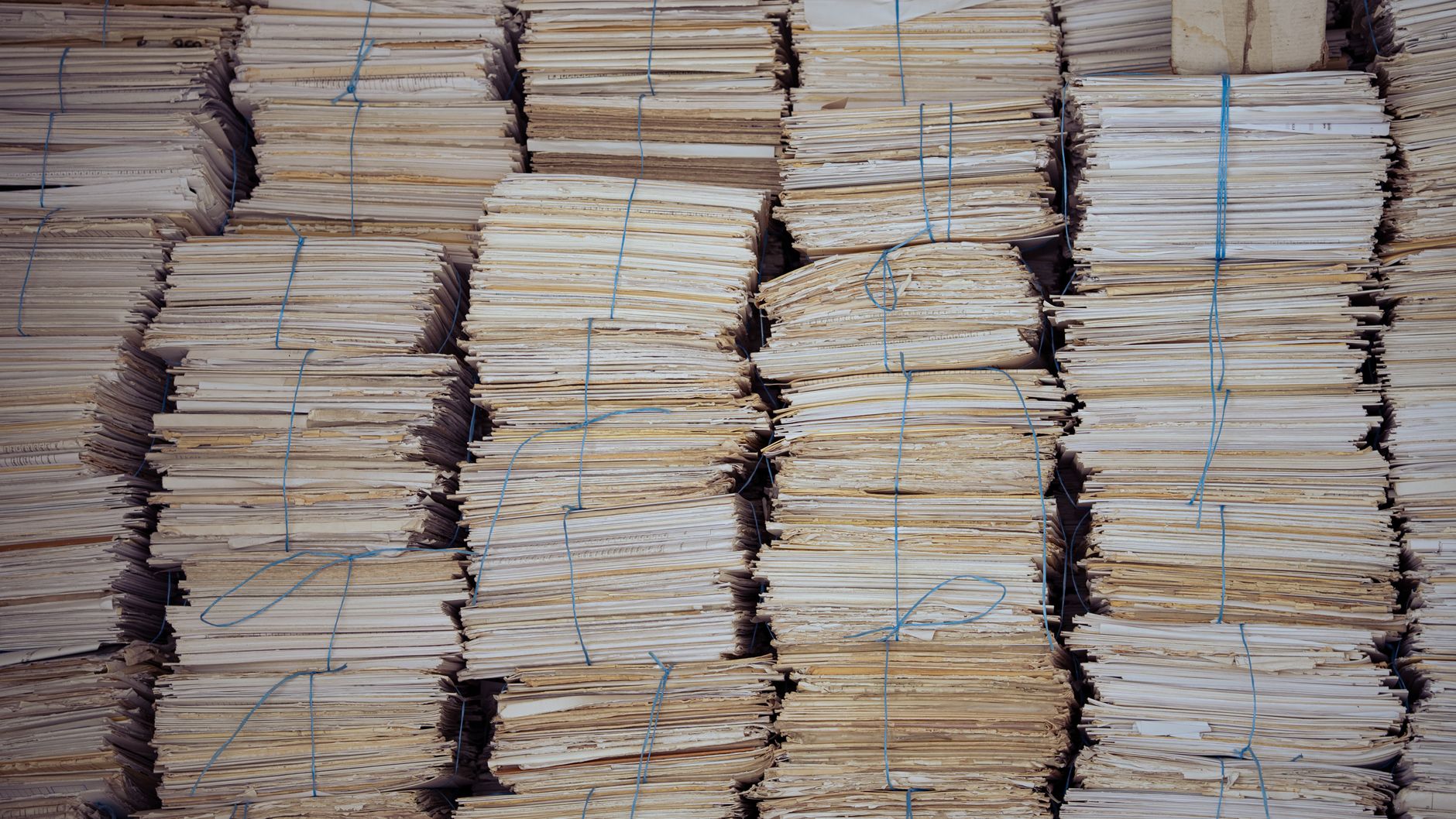 High stacks of organized, bound paper bundles create a structured and neat appearance.