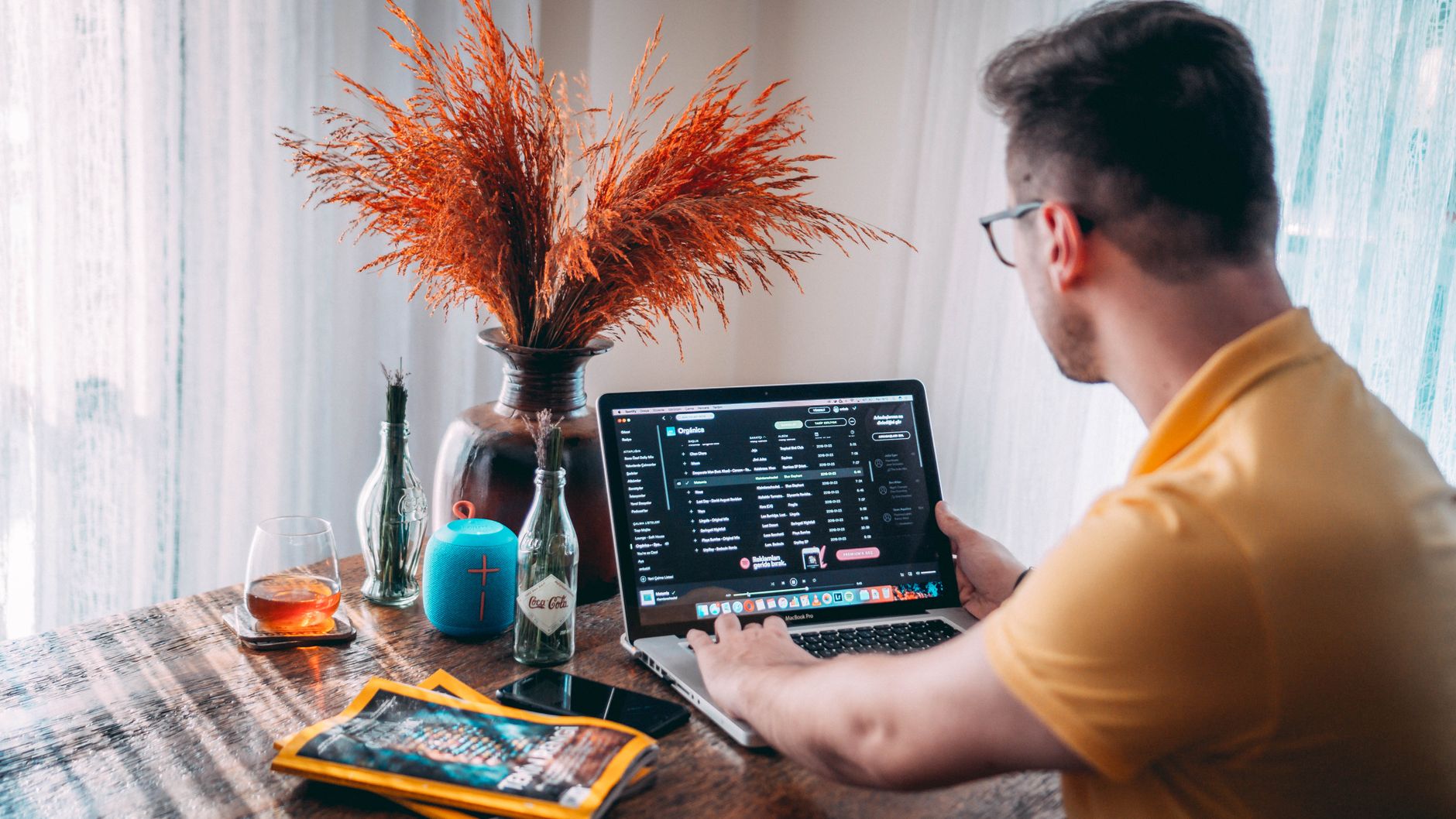 Man working from home with a laptop and vibrant decor in Istanbul. Ideal for remote work themes.