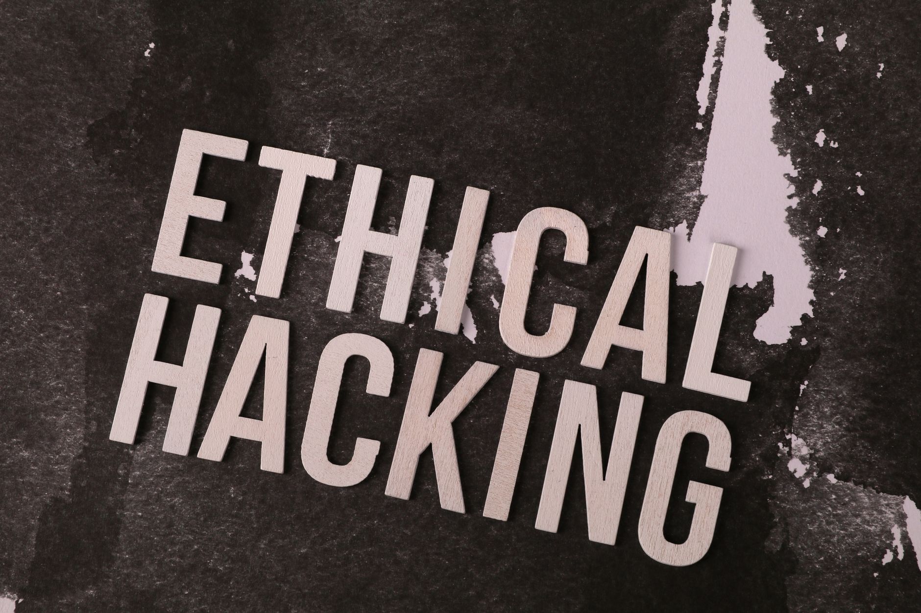 Conceptual image showing the words 'Ethical Hacking' on a textured abstract background.