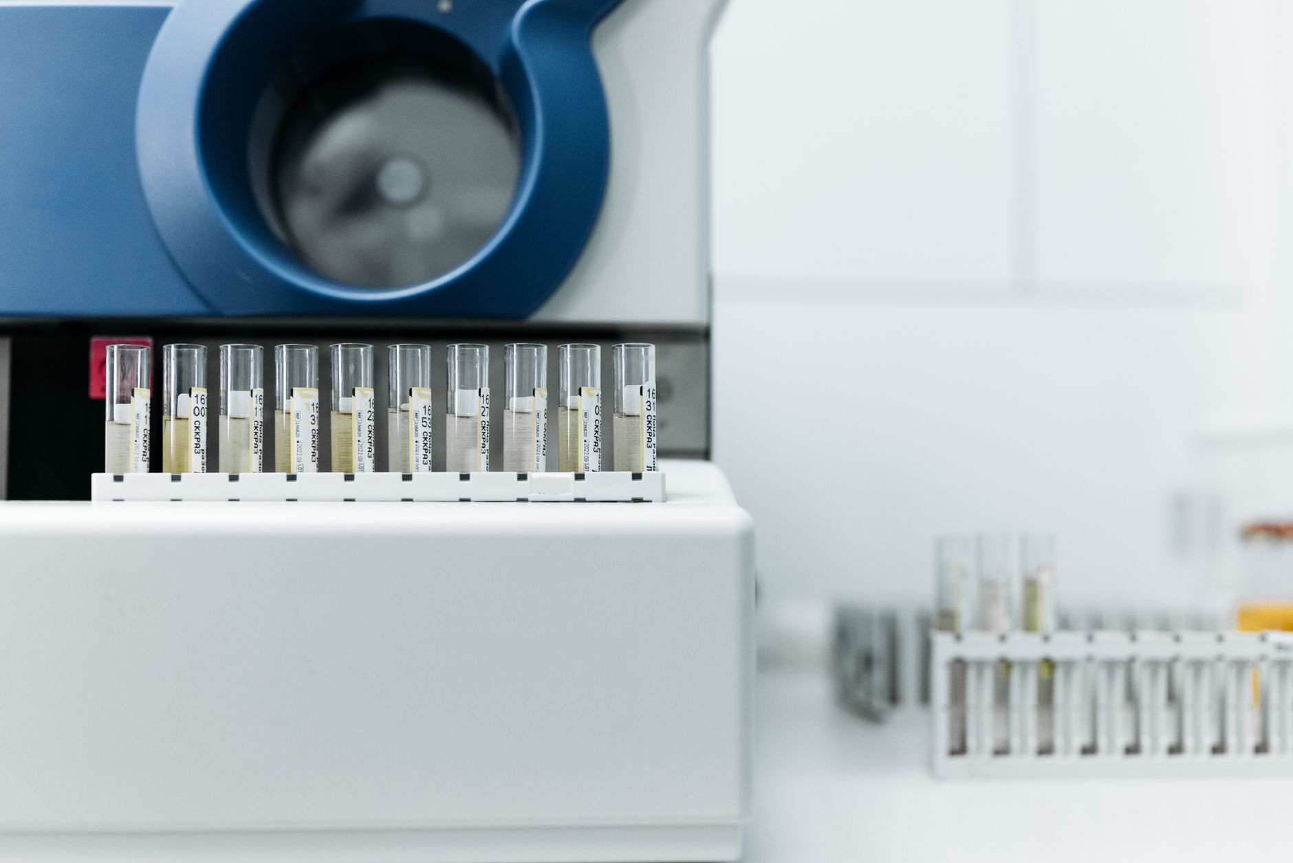 Detailed image of laboratory equipment with rows of test tubes ready for analysis.