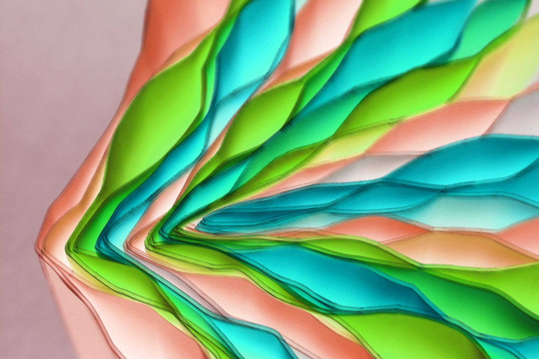 Vibrant layered paper art with green, blue, and peach colors in an abstract pattern.