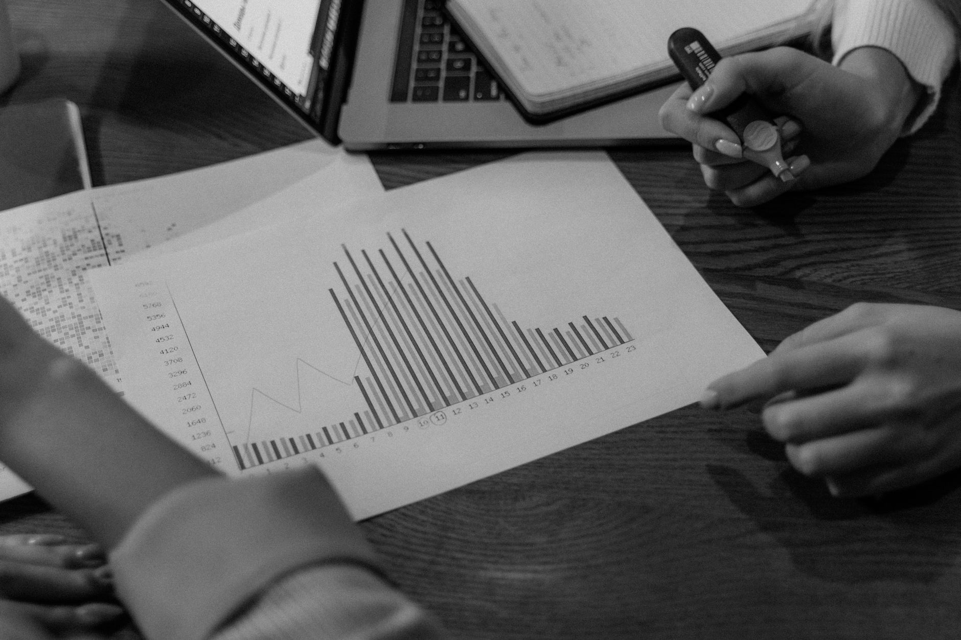 Close-up view of colleagues discussing business reports in a creative office setting.