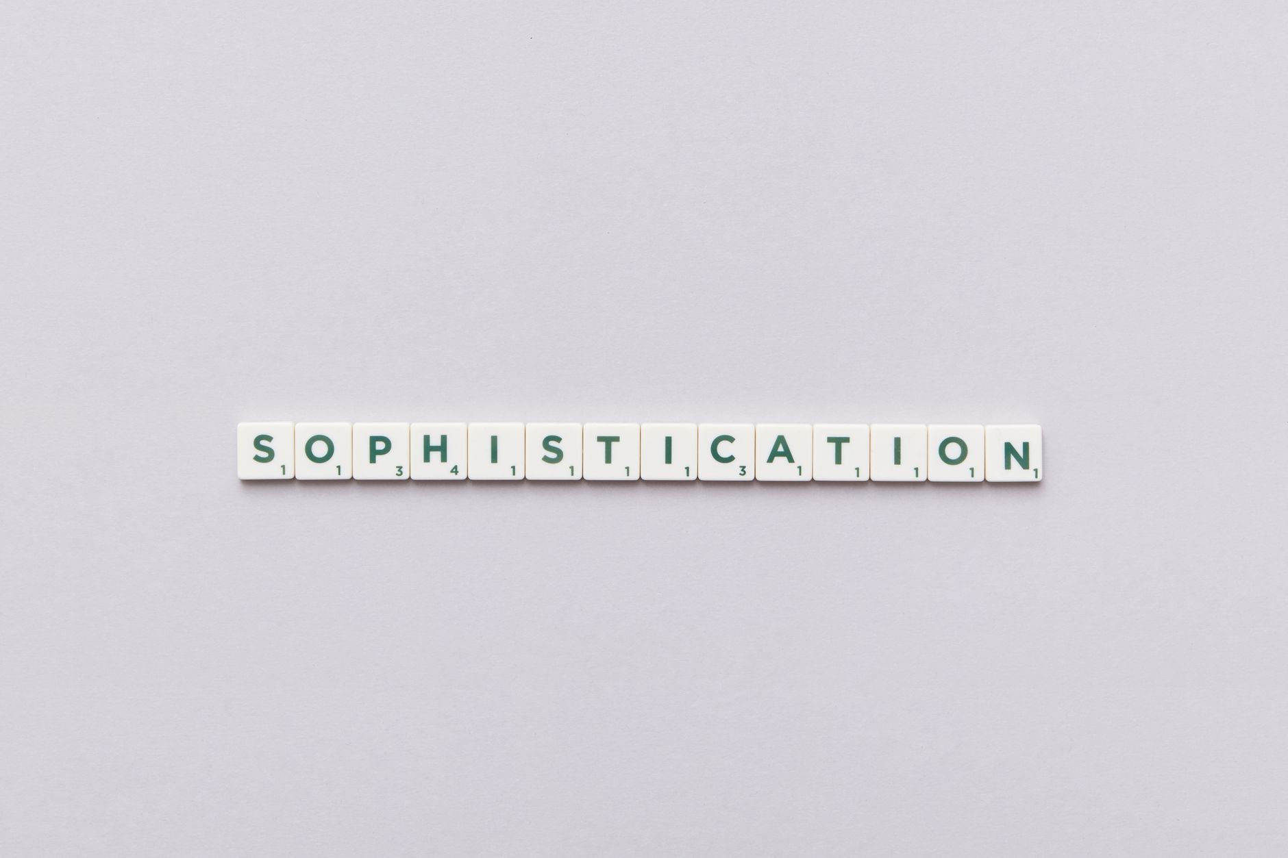 Letter tiles spelling out 'Sophistication' on a neutral background, perfect for conceptual themes.