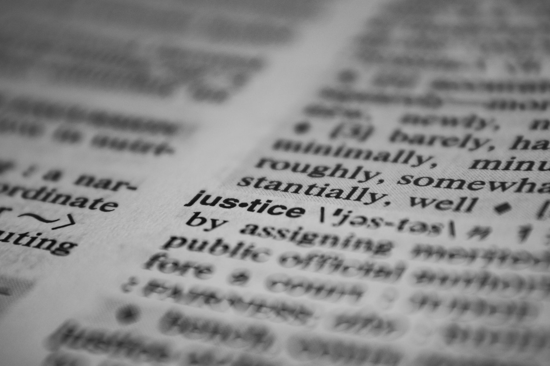 Selective focus close-up of the word justice in a dictionary, emphasizing concept clarity.