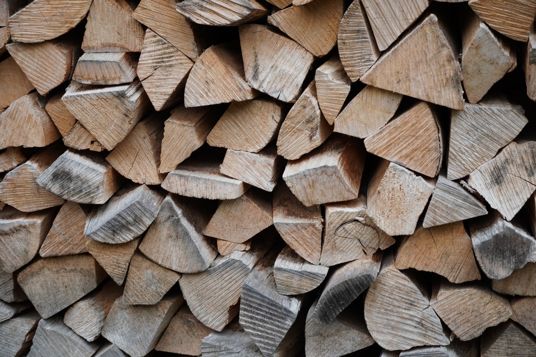High-resolution image of stacked and chopped firewood ready for use.