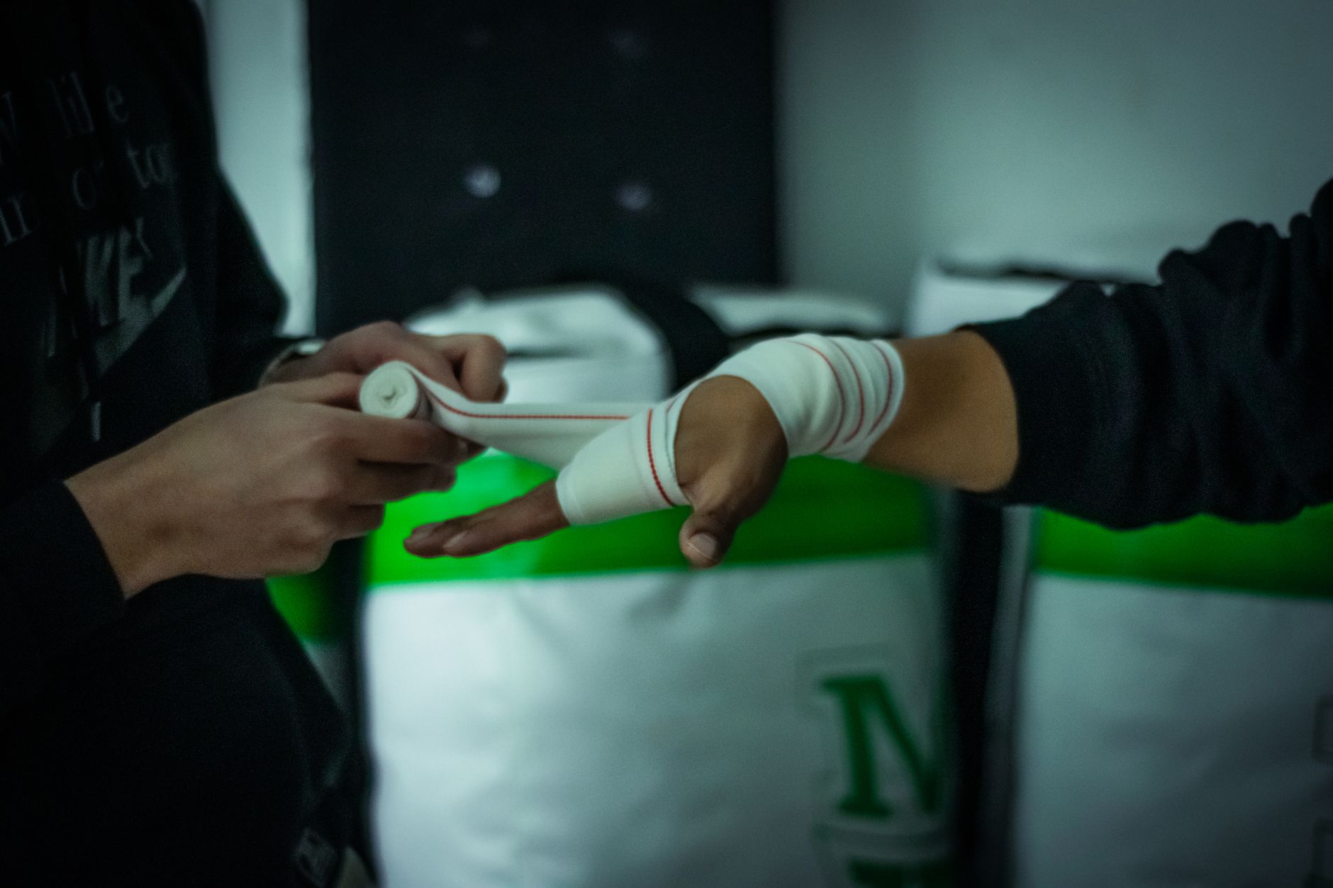 A person preparing for a boxing match by wrapping their hand, emphasizing fitness and sportsmanship.