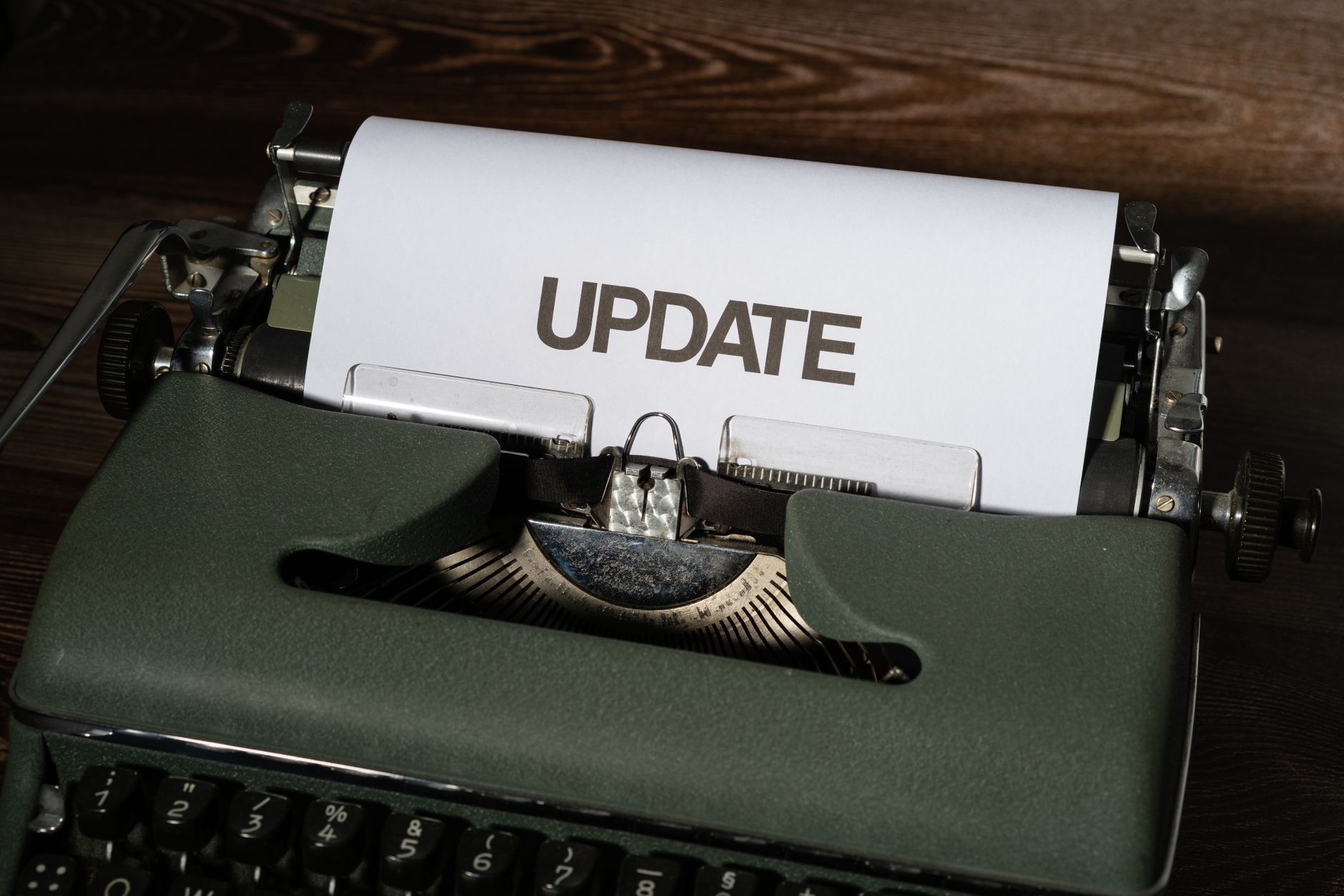 A close-up of a classic typewriter with a sheet displaying 'UPDATE' text, evoking nostalgia.