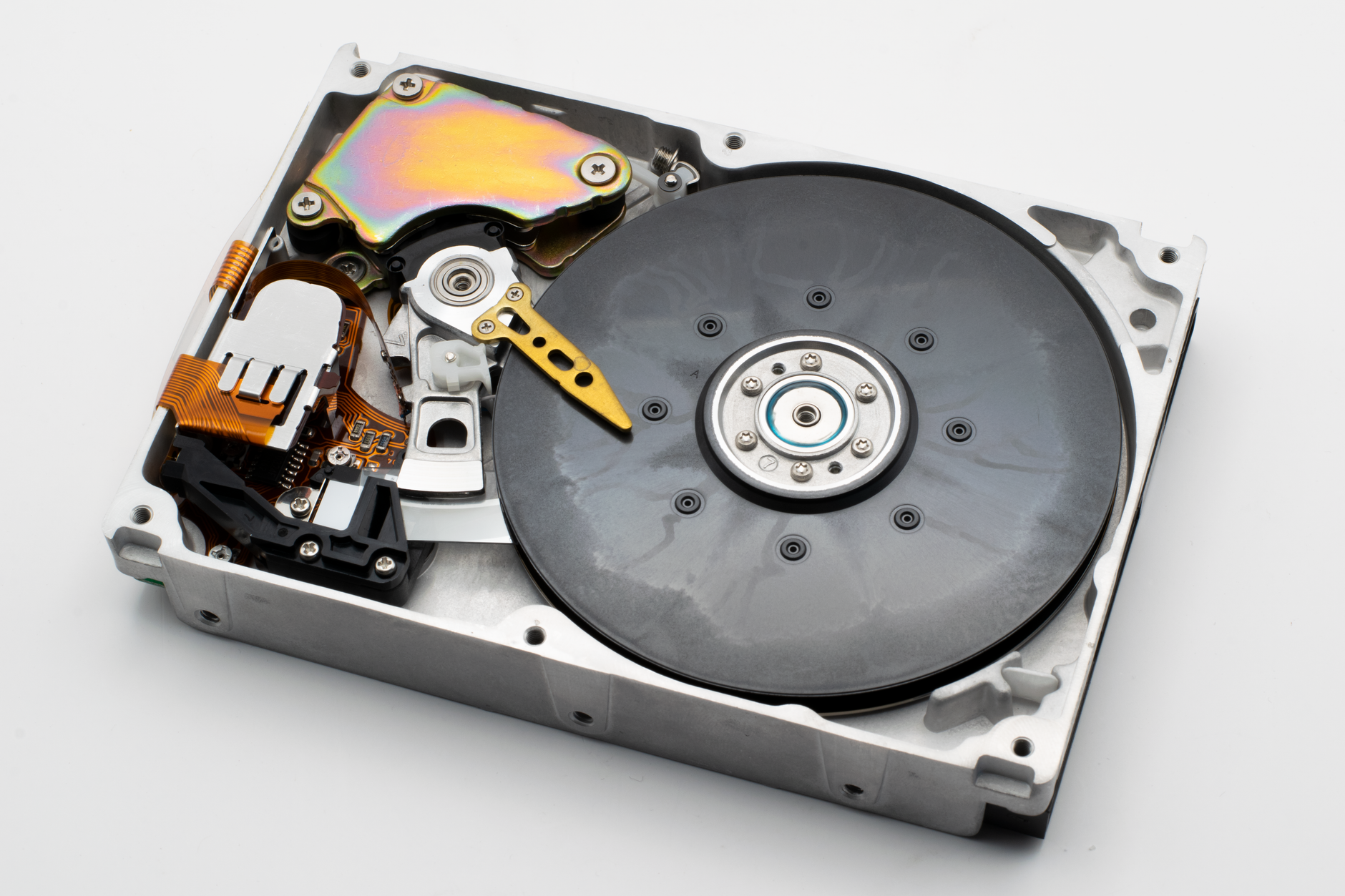 Internal view of a hard disk drive revealing its disk platter and read/write head for data storage.