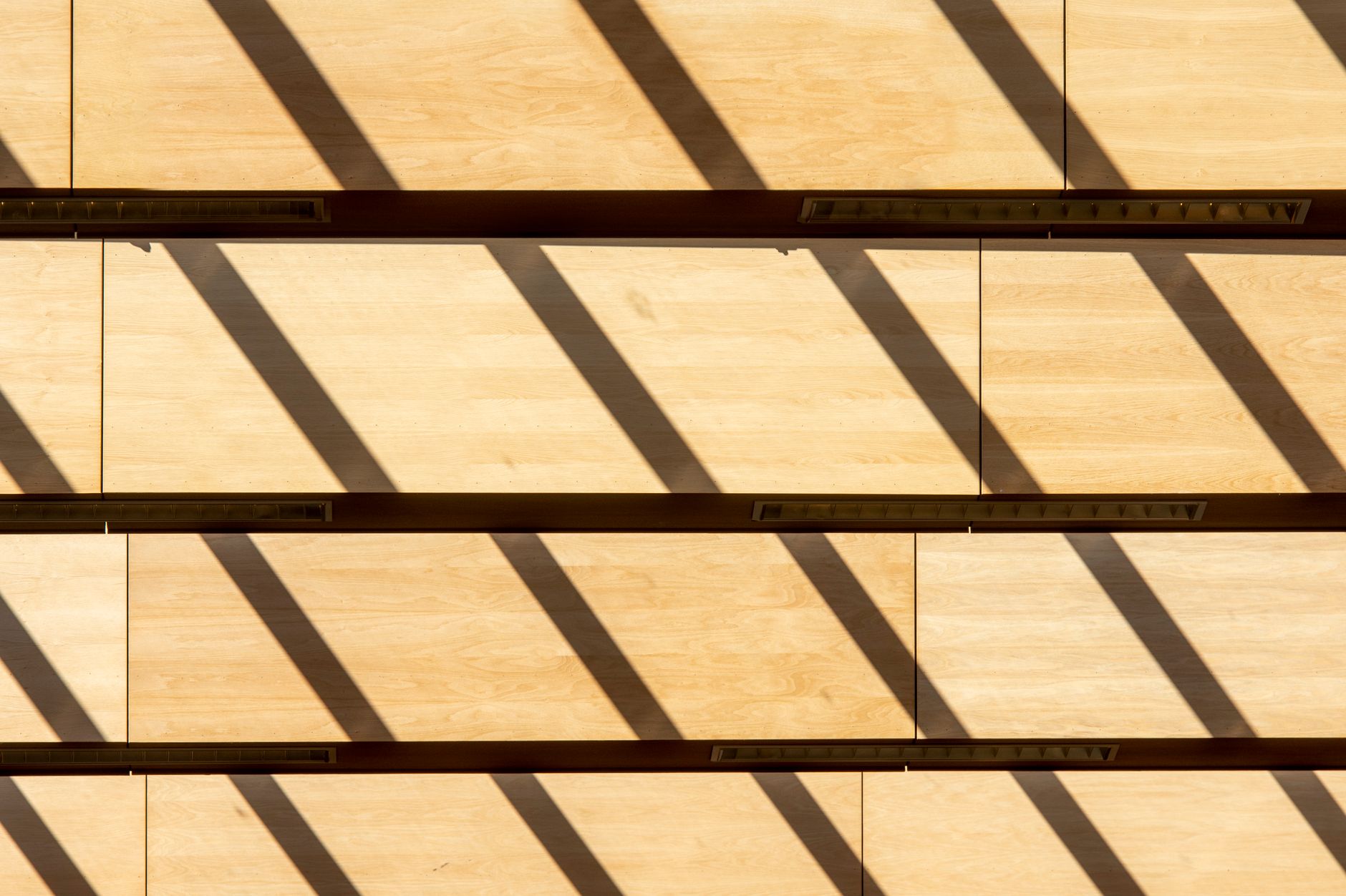 Artistic shadows and patterns on a wooden wall create a unique abstract composition.