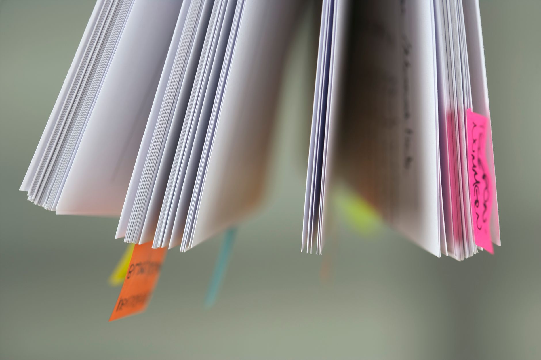 A close-up view of book pages with colorful sticky tabs, suggesting organization or study.