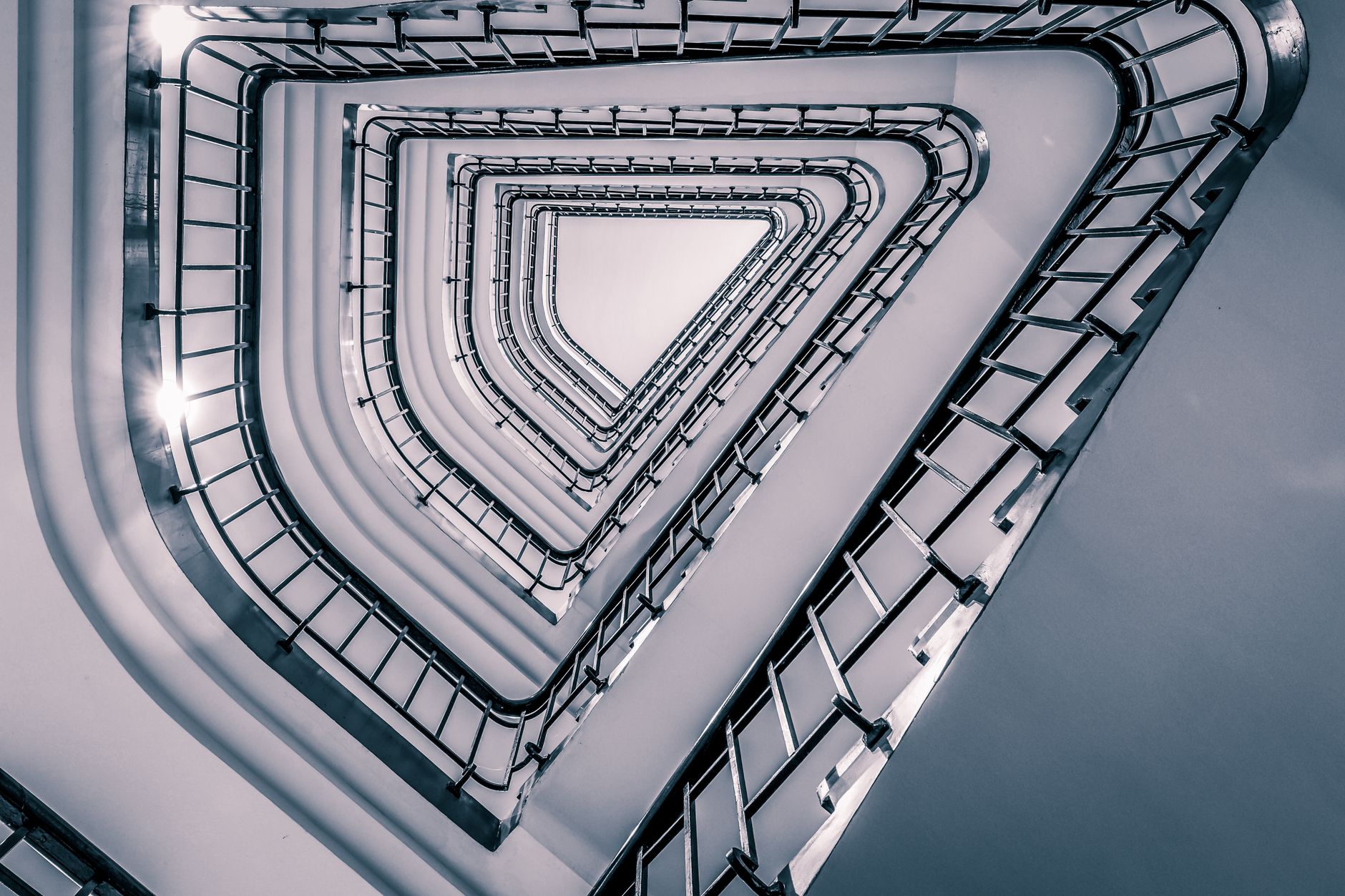 A captivating shot of a triangular staircase from below in Hamburg's modern architecture.