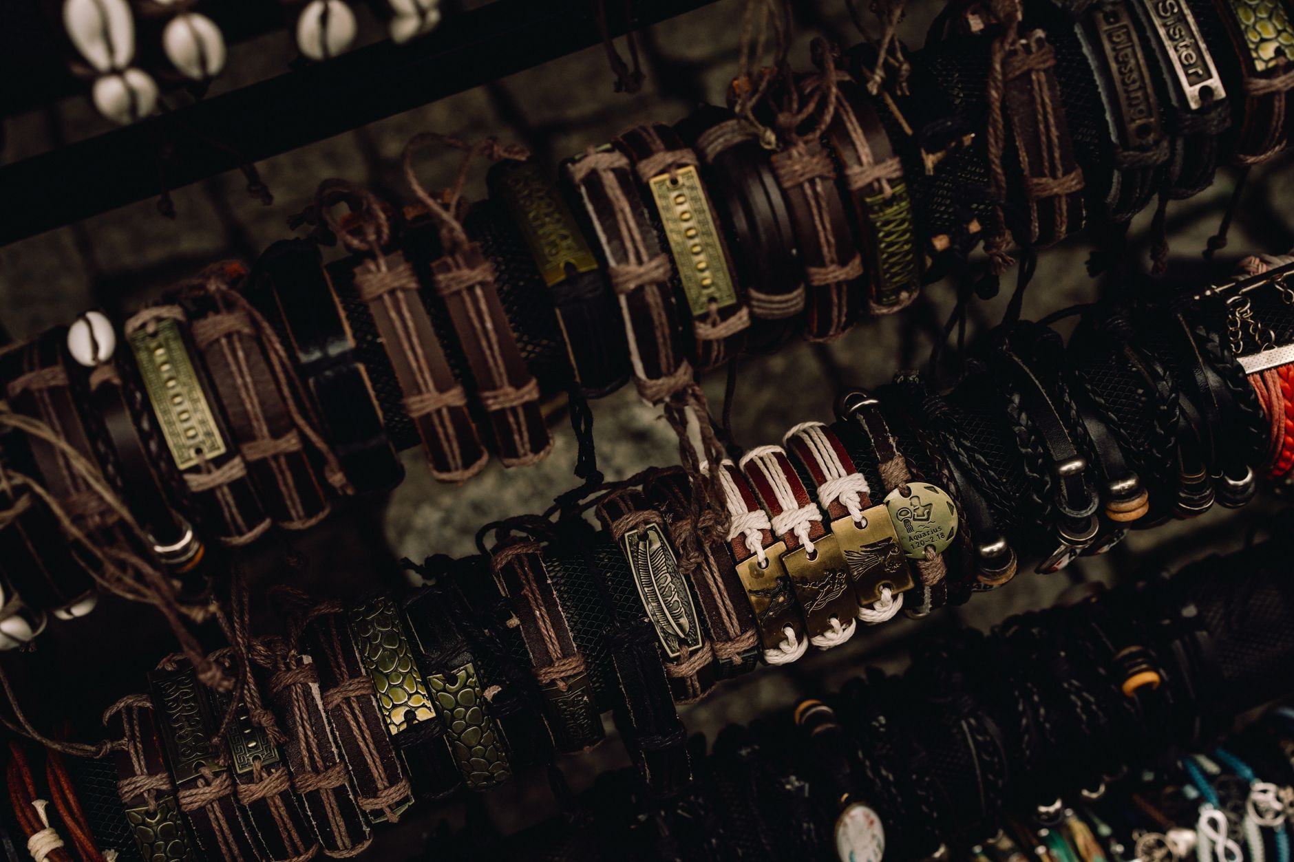 A collection of handcrafted leather bracelets displayed artistically on a rack.