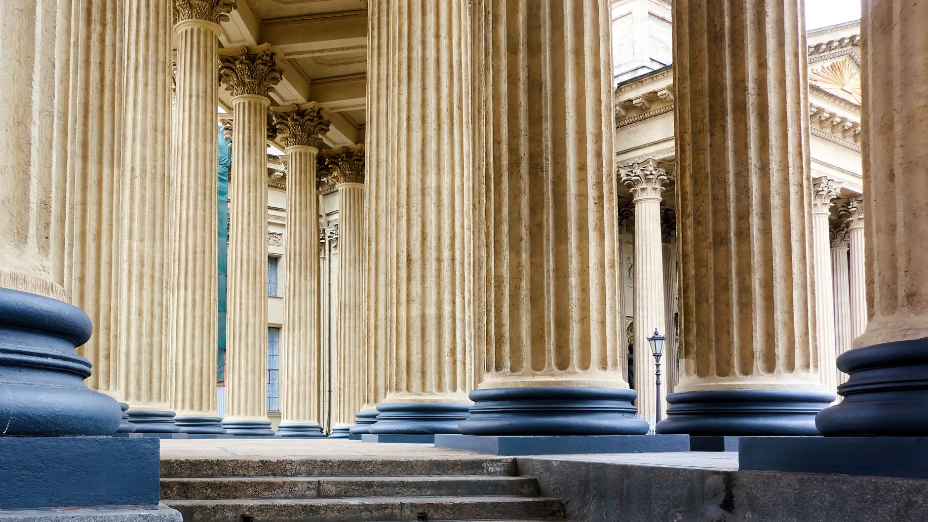 Explore the grandeur of Russian neoclassical architecture with majestic stone columns and intricate details.