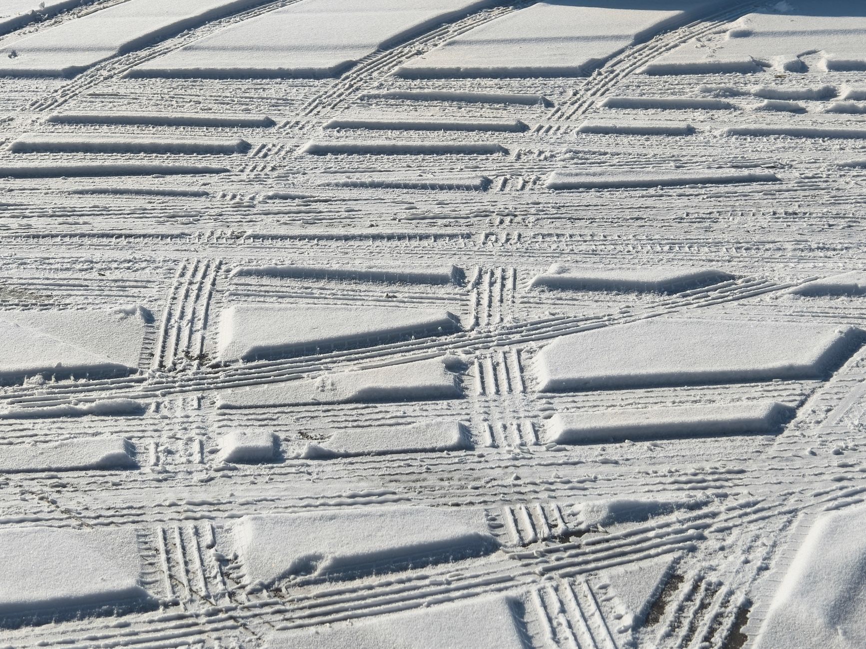 Detailed patterns of tire tracks on snow, capturing the essence of winter textures and outdoor adventure.