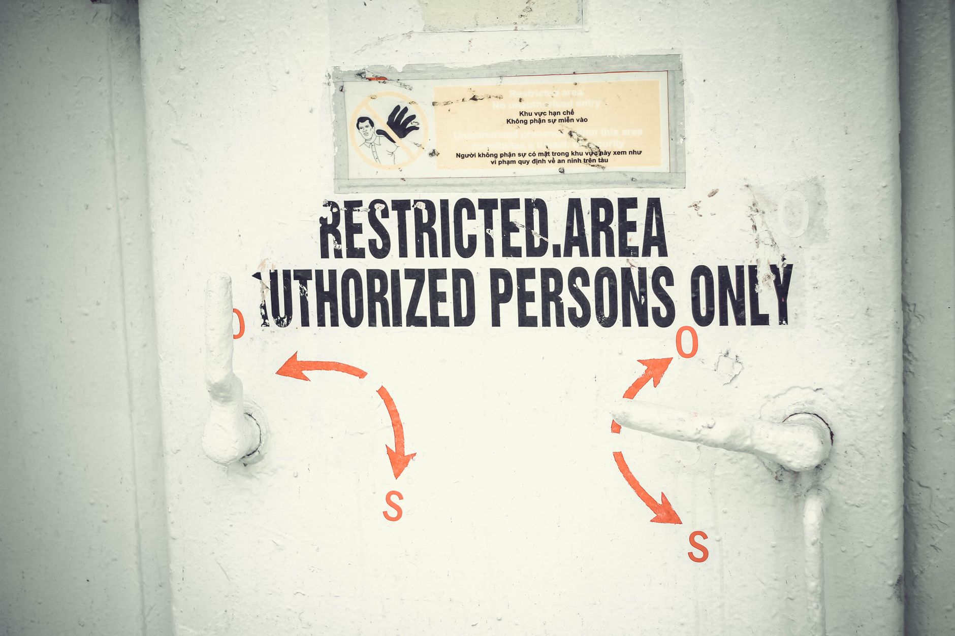 Close-up of a restricted area door with signage emphasizing authorized access only.
